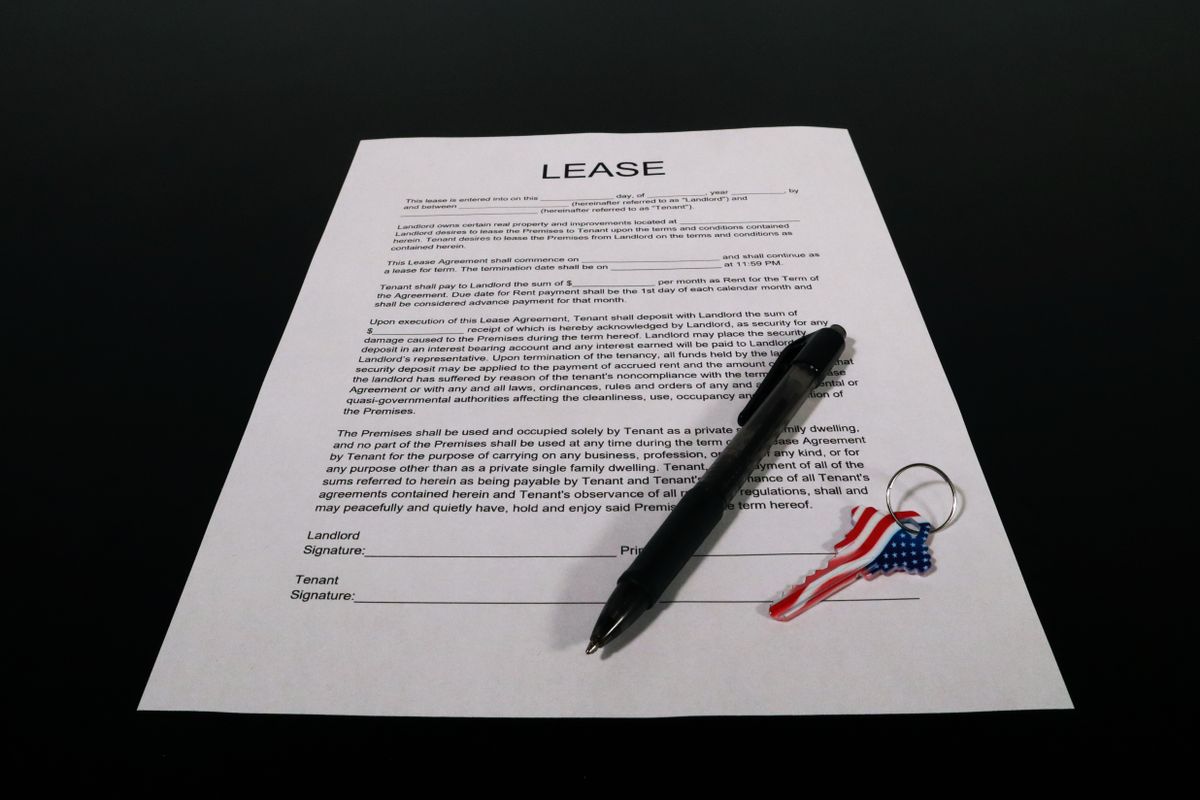 Tenant reviewing a rental lease agreement before signing